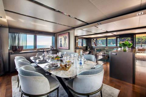 Dine in elegant style aboard this yacht, with a beautifully set table overlooking the sparkling sea.