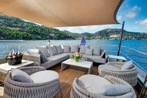 Relax on the luxurious deck of a yacht, surrounded by stunning coastal views and refreshing drinks.