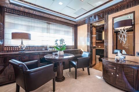 Luxurious wood finishes and plush seating create an opulent retreat aboard this elegant yacht.