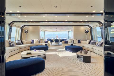 Luxurious yacht interiors offer a serene escape with plush seating and panoramic views of the sparkling sea.