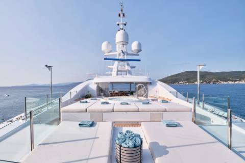 Relax on the sun-drenched deck of this luxurious yacht, complete with a soothing jacuzzi and plush loungers.