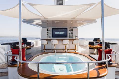 Relax and unwind in the jacuzzi or enjoy a drink at the bar on this luxurious yacht deck.
