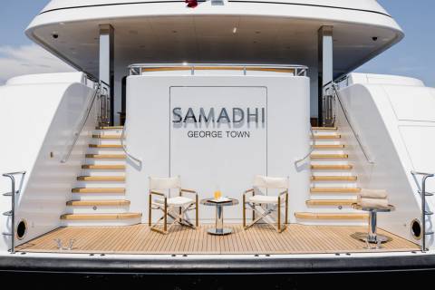Relax in style on the luxurious deck of the yacht Samadhi, complete with comfortable seating and refreshing drinks.