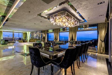 Luxurious yacht dining room with a stunning view of the ocean at dusk.