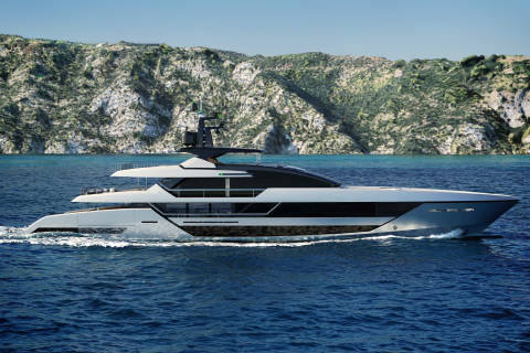 A sleek, modern yacht glides through the deep blue ocean with a rugged, green-covered mountain range in the background.