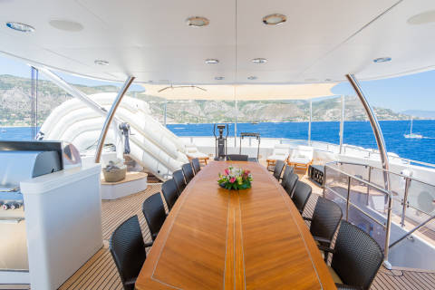 Dine al fresco on this yacht's deck, surrounded by stunning coastal views and the sparkling blue sea.