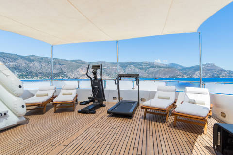 Enjoy a workout with a breathtaking view of the Mediterranean coastline from this yacht's sun-drenched deck.