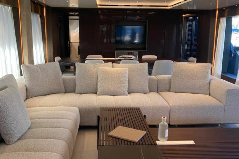Luxurious yacht interiors feature plush seating and elegant dark wood accents for ultimate comfort and style.