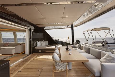 Luxurious outdoor seating and dining areas on a yacht offer the perfect setting for enjoying the sea breeze and stunning ocean views.