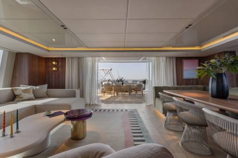 Luxurious yacht interiors seamlessly blend with the ocean views through expansive sliding doors.