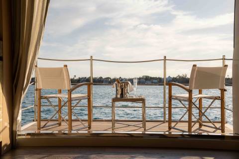 Enjoy a refreshing drink on this elegant deck overlooking the tranquil blue waters and distant shoreline.