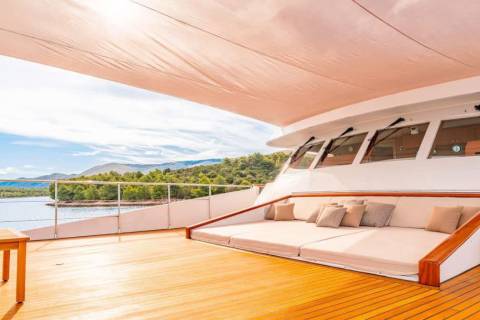 Relax on the sun-drenched deck of this luxurious yacht, surrounded by breathtaking coastal scenery.