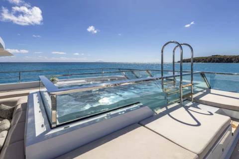 Relax in the crystal-clear waters of this luxurious yacht's infinity pool overlooking the azure sea.