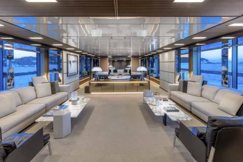 Luxurious yacht interiors offer expansive ocean views through floor-to-ceiling windows.