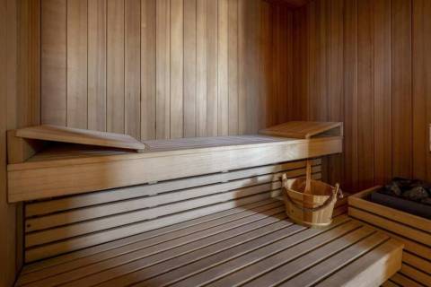Relax and unwind in the warm, natural wood of this serene sauna.