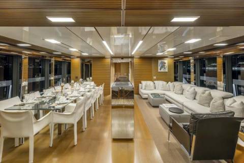 A luxurious yacht dining area and lounge offer elegant seating and panoramic views for an unforgettable voyage.