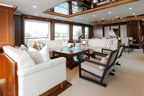 Luxurious yacht interiors offer plush seating and elegant dining areas with stunning waterfront views.
