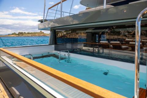 Relax in the inviting turquoise waters of this yacht's private pool while taking in the stunning coastal views.