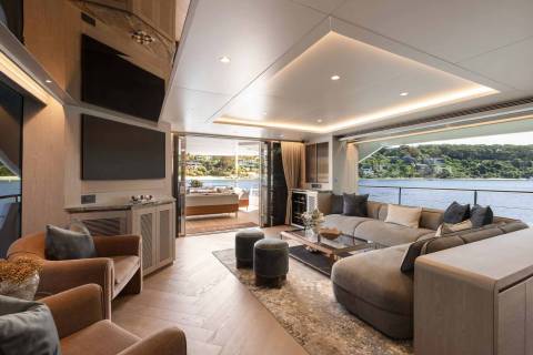 Luxurious yacht interiors open onto stunning waterfront views, blending sophisticated comfort with the natural beauty of the surroundings.