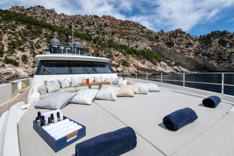 Relax on the spacious deck of this luxury yacht, surrounded by stunning Mediterranean cliffs and crystal-clear waters.