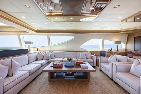 Luxurious yacht interiors feature plush seating and expansive windows offering breathtaking ocean views.