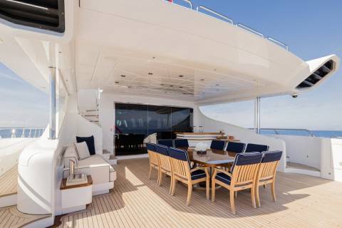 Dine al fresco on the spacious deck of this luxurious yacht, surrounded by the endless blue sea.