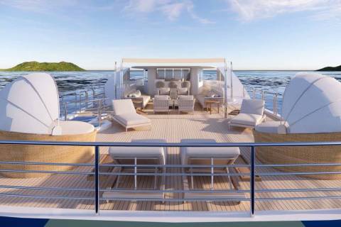 Relax on the spacious deck of this luxurious yacht, surrounded by the tranquil blue sea and distant green islands.