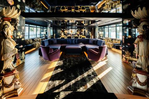 A lavishly decorated and ornate interior space with plush seating, intricate lighting fixtures, and a patterned floor, creating an opulent and inviting atmosphere.
