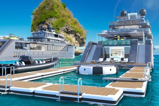 A luxurious yacht with multiple decks and amenities, docked in a picturesque setting with a rocky, verdant island in the background and crystal-clear turquoise waters surrounding it.