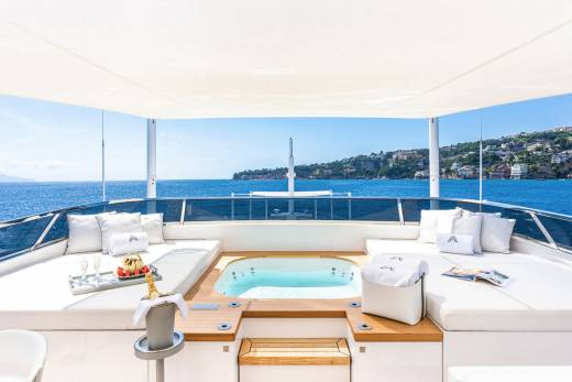Relax in the jacuzzi on this luxurious yacht with stunning views of the Mediterranean coastline.