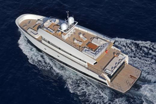 A sleek white yacht glides through the deep blue ocean, leaving a foamy wake in its path.