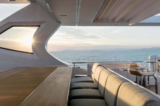 Enjoy a breathtaking sunset over the tranquil sea from the luxurious deck of this elegant yacht.