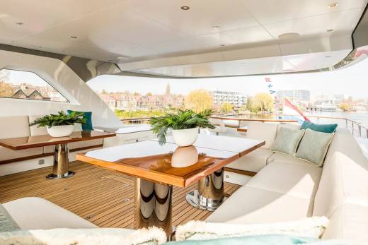 Relax on the spacious deck of this luxurious yacht, enjoying the scenic waterfront views and comfortable seating.