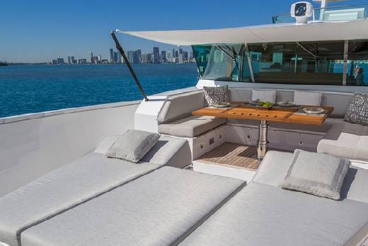 Relax on the spacious deck of this luxury yacht, enjoying the stunning city skyline and turquoise waters.