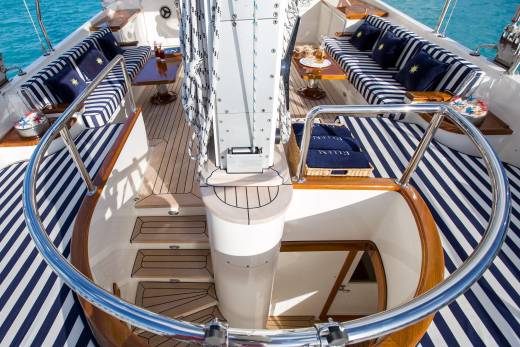 Luxurious yacht seating with navy and white stripes invites relaxation on a sun-drenched deck.