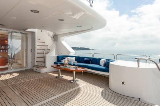 Relax on the spacious deck of this luxurious yacht, enjoying the ocean breeze and stunning coastal views.