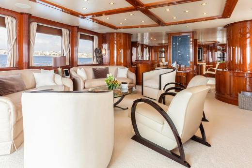 Luxurious wood paneling and plush seating create an elegant salon aboard this opulent yacht.