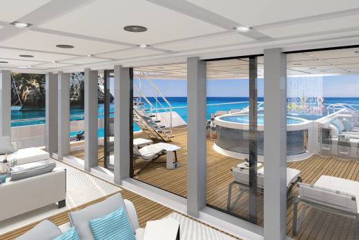Luxurious yacht deck features a jacuzzi, waterfall, and comfortable seating overlooking a stunning turquoise ocean.