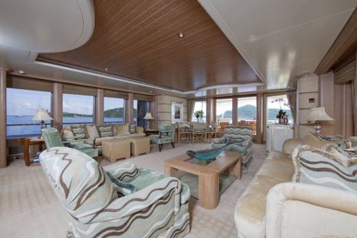 Luxurious yacht salon offers panoramic ocean views and comfortable seating arrangements for relaxation and socializing.
