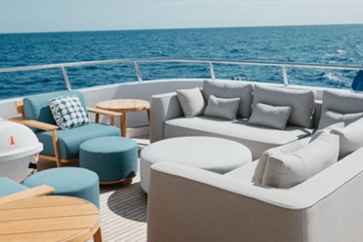 Relax on the plush seating of this luxurious yacht deck, surrounded by the endless blue ocean.