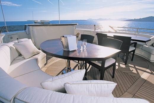 Relax on the luxurious deck of a yacht with a chilled bottle of champagne and stunning ocean views.