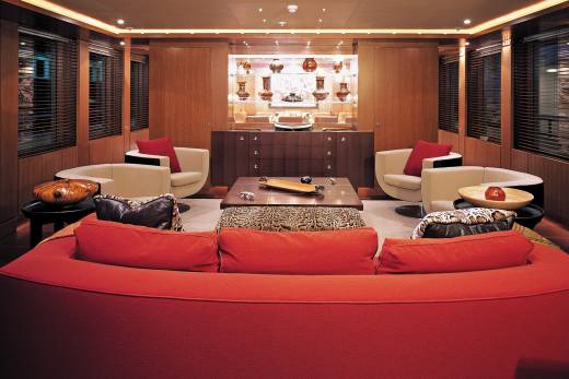 Luxurious red seating and unique decor create a sophisticated lounge aboard this opulent yacht.