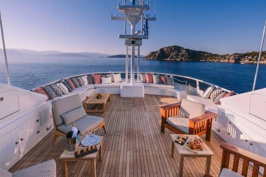 Relax on the spacious deck of a luxury yacht, surrounded by the azure waters and picturesque islands.