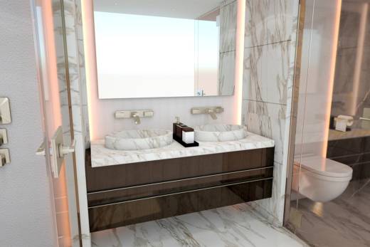 Luxurious marble and warm lighting create a serene and elegant atmosphere in this modern bathroom.