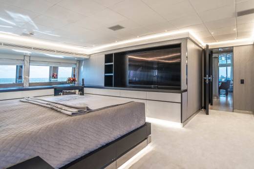 Luxurious yacht master suite offers stunning ocean views and modern entertainment.