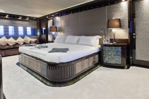 Luxurious yacht interiors feature a plush king-sized bed, elegant seating, and ambient lighting for ultimate comfort.