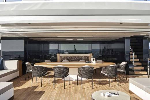 Luxurious yacht deck seating and dining areas offer a sophisticated outdoor experience with stunning ocean views.
