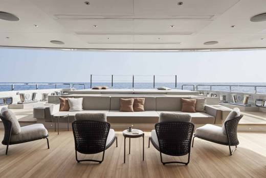 Relax on the spacious deck of this luxurious yacht, enjoying the serene ocean views and comfortable seating.