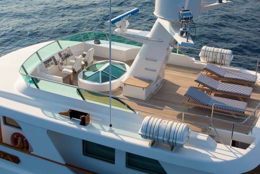 Relax on the sun-drenched deck of this luxurious yacht, surrounded by the tranquil blue sea.