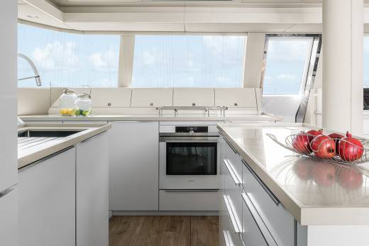 A modern yacht kitchen with a stunning ocean view offers a bright and airy space for culinary adventures.